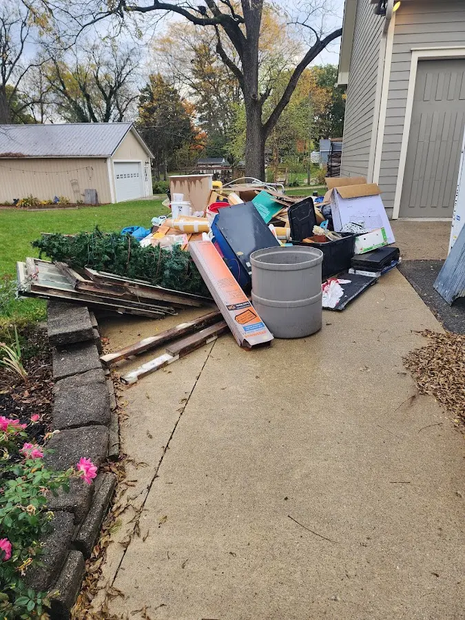 Dumpster being loaded with debris for Commercial Dumpster Rental in Timber Pines